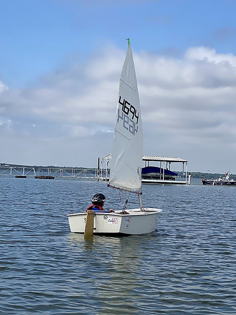 A DCYC youth sailor heading out under sail on Lake Lewisville