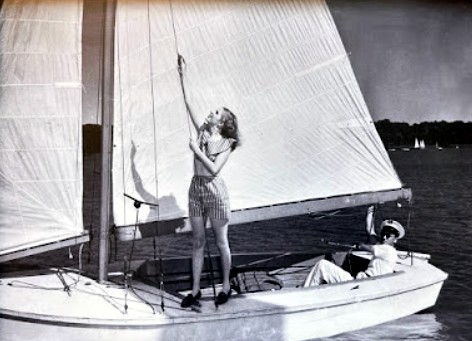 A young DCYC sailor trims the mainsail underway on Lake Lewisville, founding era